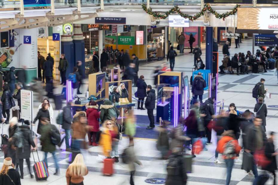 Passengers in London Liverpool Street Station Walking In Front of the Diageo Johnnie Walker Pop Up Kiosk