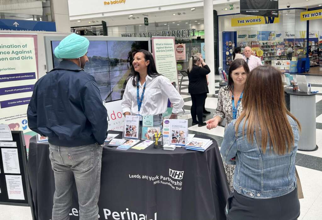 Leeds Perinatal Team promoting at White Rose Shopping Centre with tables and leaflets